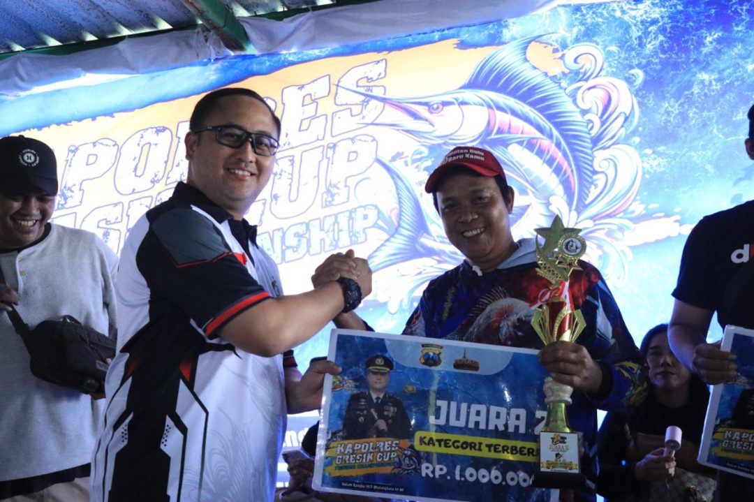 Kapolres Gresik menyerahkan hadiah kepada pemenang Kapolres Gresik Cup Fishing Championship dalam rangka Hari Bhayangkara ke-80.